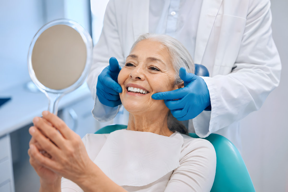 Smiling Elderly Woman at Dental Appointment Holding Mirror in Modern Clinic